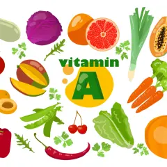 Légumes et fruits colorés, dont carottes, courge, poivron, tomate, mangue, papaye, et agrumes, illustrant des aliments riches en vitamine A.