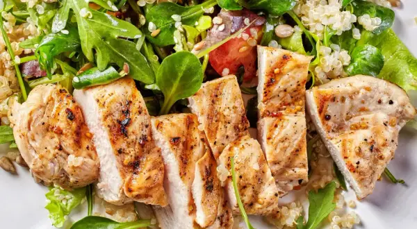 Poulet grillé et quinoa avec salade verte. Un repas sain pour votre menu semaine régime ménopause.