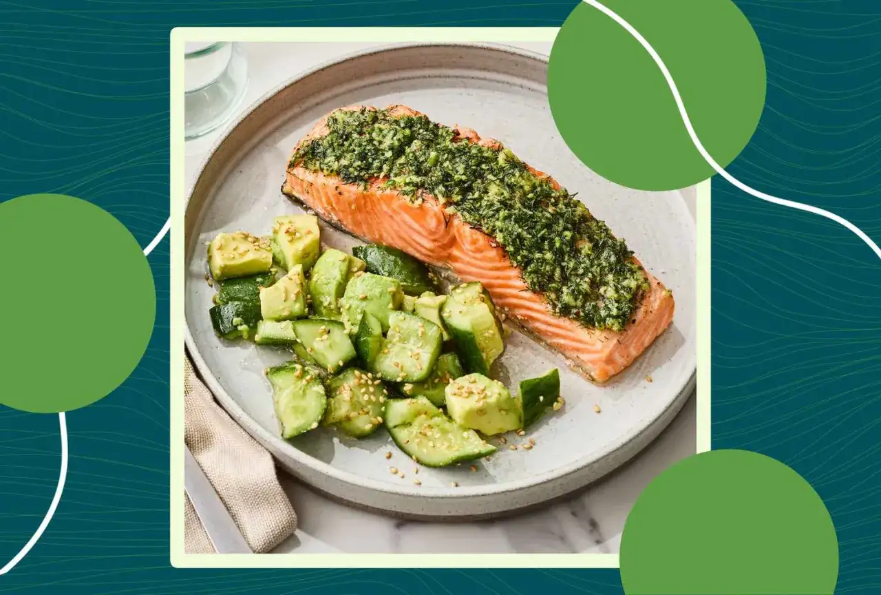 Filet de saumon herbacé avec salade d'avocat et concombre. Une alimentation saine peut aider à gérer l'aponévrosite plantaire.